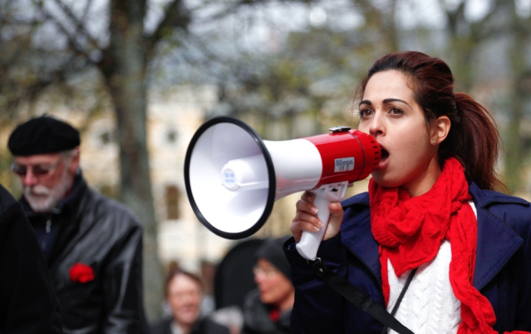 A protester speaking through a megaphone.