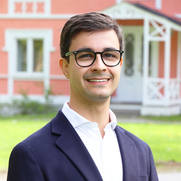 Tiago Bernardino standing in front of pink house