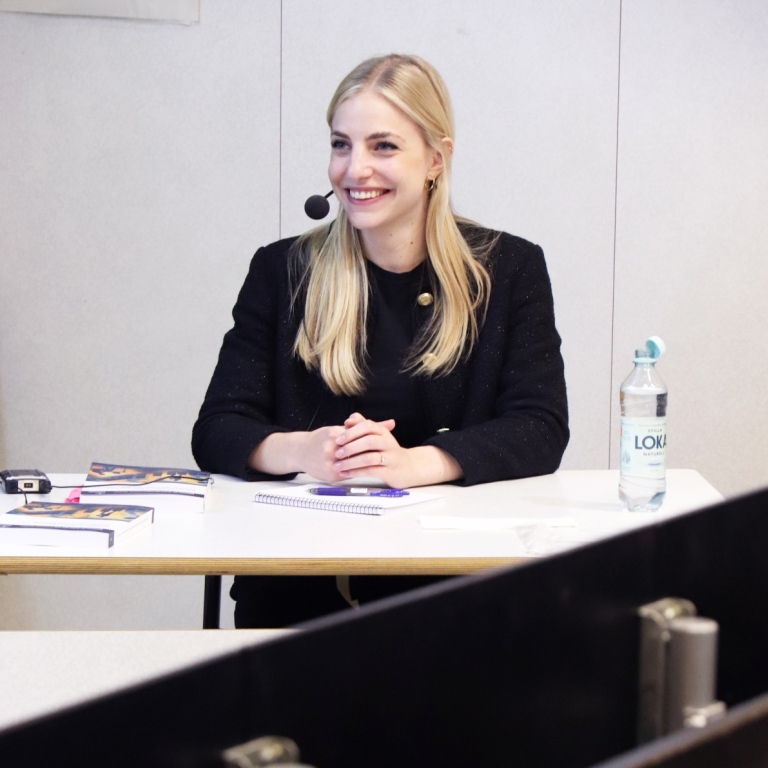 Patrizia sitting at a desk at her defense