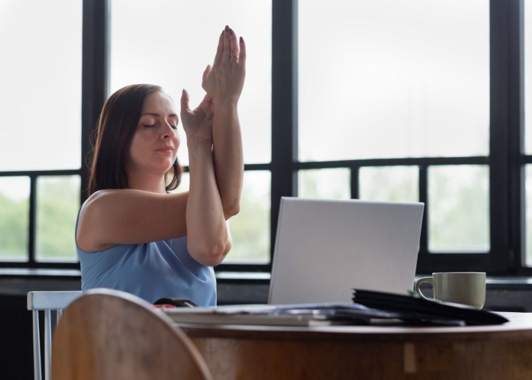 Women doing yoga at the office.