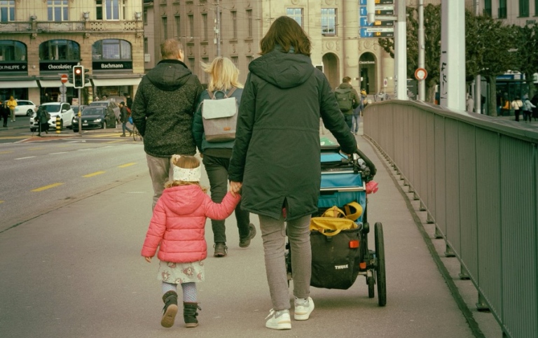 A family walking downa a street