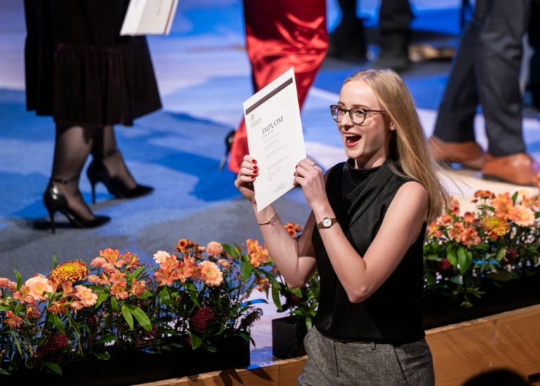 Happy student with diploma.