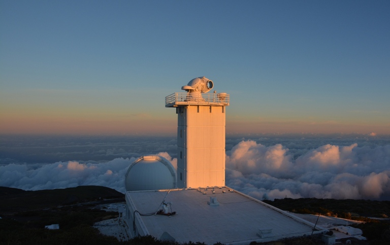 A white tower above clouds