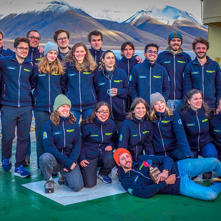 The 21 students in the research school gathered on helicopter deck.