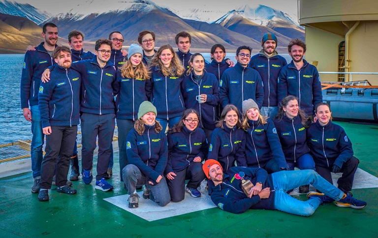 The 21 students in the research school gathered on helicopter deck.