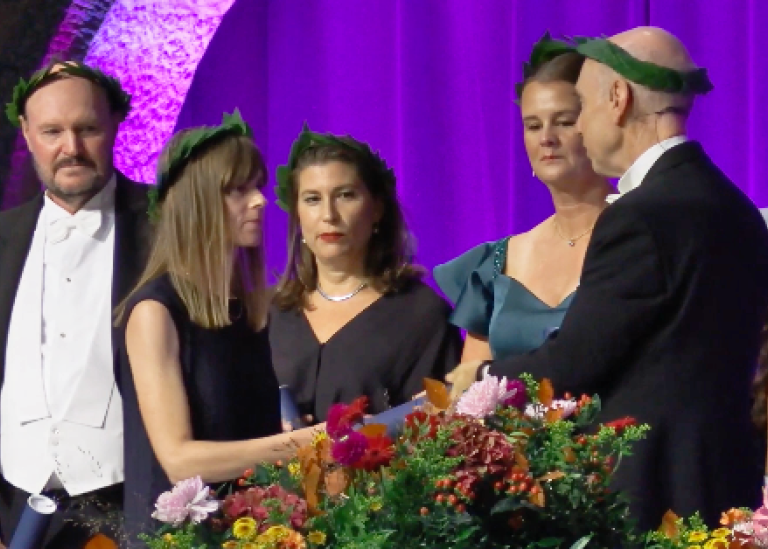 Hedvig Härnsten mottar sitt diplom av dekan Stefan Helgesson.
