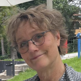 Smiling Matilda with shortish hair and glasses