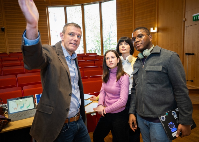 A lecturer explaining something to his students.