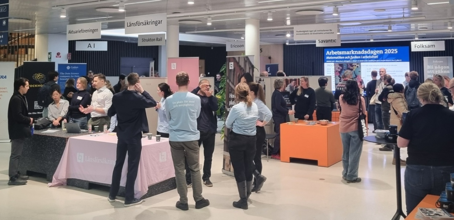 About 25 people at the career fair, chatting in groups.